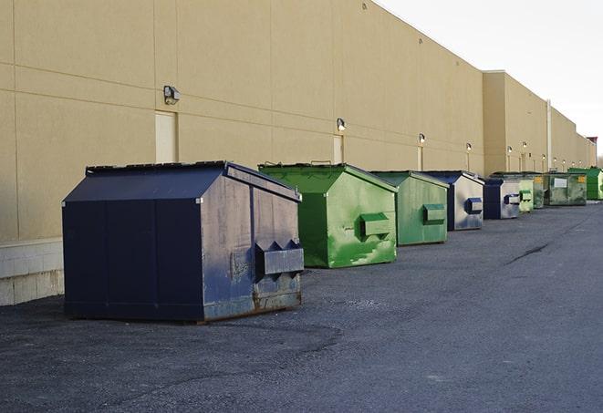 a collection of bright and vibrant dumpsters in a construction zone in Alpine, AL